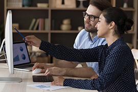 A project coordinator and a web developer work together on a project in close-up.